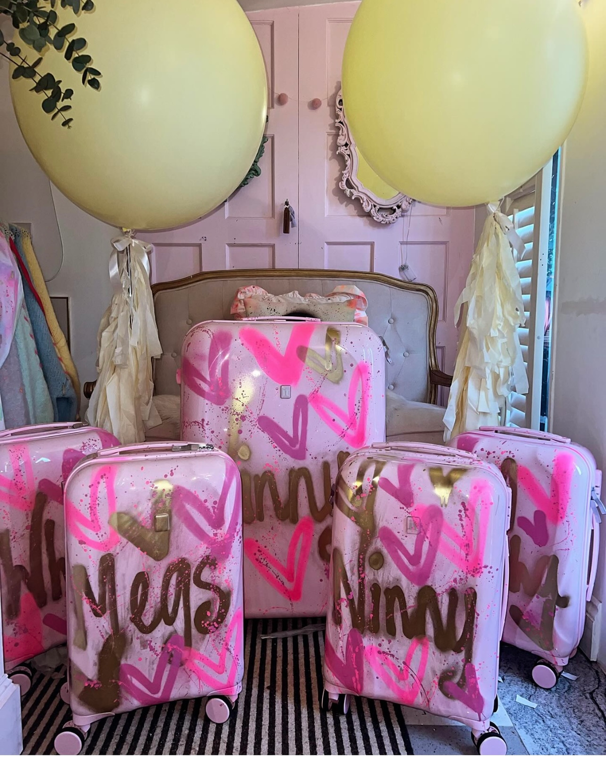 Large baby pink spray painted suitcases 🩷