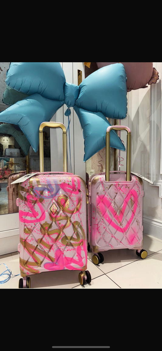 Large baby pink spray painted suitcases 🩷